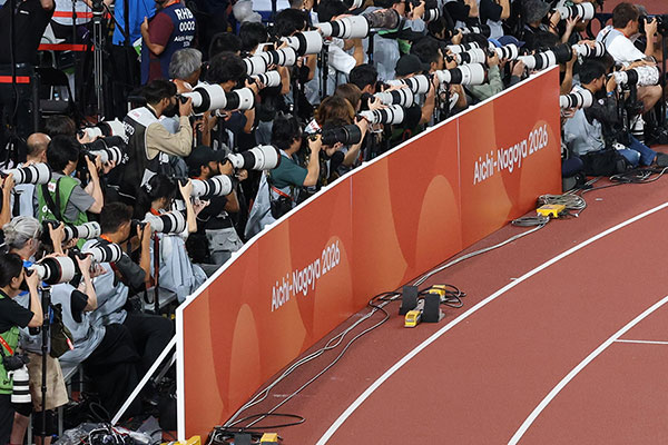 Photographers capturing a definitive moment during the Games