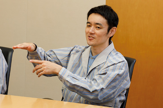 Interview scene with a Canon developer describing ink technology.